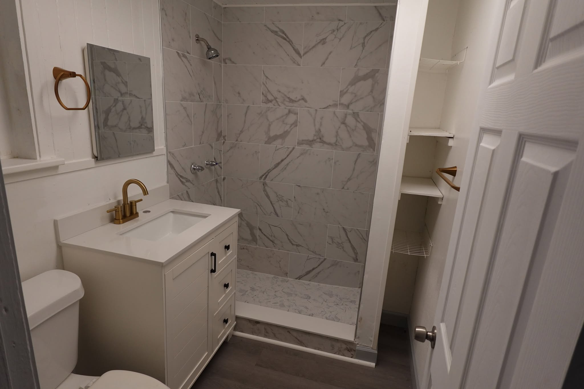 Stylish bathroom with upgraded fixtures and marble tile shower
